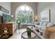Bright living room boasts a large arch window and comfortable seating area at 280 Selkirk Ln, Johns Creek, GA 30097