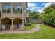 Backyard with a covered patio featuring a full outdoor kitchen and manicured landscaping at 280 Selkirk Ln, Johns Creek, GA 30097