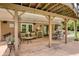 Covered patio features neutral decor, ceiling fans and views of the meticulously kept yard and garden at 280 Selkirk Ln, Johns Creek, GA 30097