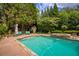 Inviting in-ground pool with stone accents and lush landscaping provides a private backyard oasis at 280 Selkirk Ln, Johns Creek, GA 30097