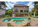 Backyard view featuring a swimming pool, connected hot tub, and outdoor entertaining space at 280 Selkirk Ln, Johns Creek, GA 30097