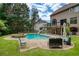 Backyard with a refreshing swimming pool, attached hot tub, deck, and patio furniture at 280 Selkirk Ln, Johns Creek, GA 30097