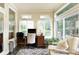 Sunny sunroom, featuring views to the backyard, creates the perfect work-from-home office at 280 Selkirk Ln, Johns Creek, GA 30097