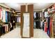 Spacious walk-in closet features custom shelving, hanging rods, and a full-length mirror at 280 Selkirk Ln, Johns Creek, GA 30097