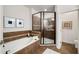The bathroom features a tub, walk-in shower, neutral tile, and recessed lighting at 3331 Vintage Se Cir, Smyrna, GA 30080