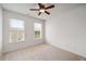 Bright bedroom with two windows, neutral carpet, and a ceiling fan at 3331 Vintage Se Cir, Smyrna, GA 30080