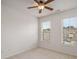 A sunny bedroom with two windows, a ceiling fan, and neutral carpet at 3331 Vintage Se Cir, Smyrna, GA 30080