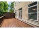A wooden deck featuring a painted backdrop for privacy and a nice view of trees in the neighborhood at 3331 Vintage Se Cir, Smyrna, GA 30080