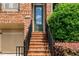 A close-up view of the front door and entrance steps of the brick townhome at 3331 Vintage Se Cir, Smyrna, GA 30080