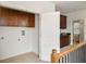 Upstairs hallway with washer/dryer hookups and snack bar with wooden cabinets at 3331 Vintage Se Cir, Smyrna, GA 30080