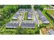 An aerial view of a townhome community featuring symmetrical streetscapes and lush green spaces between buildings at 6125 Langdon Way, Cumming, GA 30028