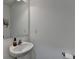 Small half bathroom featuring a white sink, faucet, mirror and toilet paper holder at 6125 Langdon Way, Cumming, GA 30028