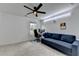 Versatile bedroom provides a comfortable couch, ceiling fan, and dedicated workspace at 6125 Langdon Way, Cumming, GA 30028