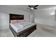 Bedroom featuring neutral carpet, white walls, two windows, and a dark-stained wood bed frame at 6125 Langdon Way, Cumming, GA 30028