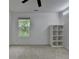 Well-lit bedroom features a ceiling fan, neutral walls, and minimalist decor at 6125 Langdon Way, Cumming, GA 30028