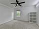 Bright bedroom featuring a ceiling fan, neutral walls, and minimalist decor at 6125 Langdon Way, Cumming, GA 30028