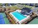 Aerial view of a large community pool with a playground and tennis courts, ideal for Gathering fun and active living at 6125 Langdon Way, Cumming, GA 30028