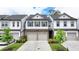 Charming townhome featuring stone accents, attached garages, manicured landscaping and a welcoming curb appeal at 6125 Langdon Way, Cumming, GA 30028