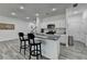 Modern kitchen with white cabinets, granite countertops, stainless steel appliances and a kitchen island with seating at 6125 Langdon Way, Cumming, GA 30028