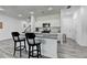 Bright kitchen with white cabinets, granite counters, stainless appliances, and island with seating at 6125 Langdon Way, Cumming, GA 30028