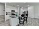 Bright kitchen featuring white cabinets, granite countertops, stainless steel appliances, and island with seating at 6125 Langdon Way, Cumming, GA 30028