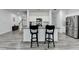 Spacious kitchen featuring granite counters, stainless steel appliances, and an island with bar stools at 6125 Langdon Way, Cumming, GA 30028