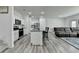 Spacious kitchen with granite counters, island with bar seating, and stainless steel appliances at 6125 Langdon Way, Cumming, GA 30028
