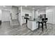 Well-lit kitchen with white cabinetry, granite counters, stainless steel appliances, and island seating at 6125 Langdon Way, Cumming, GA 30028