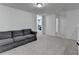 Upstairs living area features a sofa, neutral carpet, and white walls for a simple look at 6125 Langdon Way, Cumming, GA 30028
