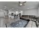 Spacious living room with a kitchen island, stairs, hardwood floors, and modern lighting at 6125 Langdon Way, Cumming, GA 30028