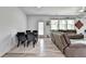Open concept living room with a dining table, large sofa, and outdoor access at 6125 Langdon Way, Cumming, GA 30028