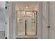 Modern shower with sliding glass doors and built-in shelving in the bathroom at 6125 Langdon Way, Cumming, GA 30028