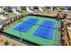 Aerial view of well-maintained tennis courts within a community, providing residents with recreational opportunities at 6125 Langdon Way, Cumming, GA 30028