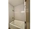 This bathroom boasts a pristine white bathtub with a showerhead against a tiled backdrop, creating a calming space at 1153 Reynolds Square Ln # 16, Atlanta, GA 30307