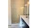 Close-up of a glass shower with a gray tiled floor and a bench at 1153 Reynolds Square Ln # 16, Atlanta, GA 30307