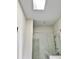 Bathroom showcasing white walls, skylight, and a glass shower at 1153 Reynolds Square Ln # 16, Atlanta, GA 30307