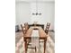 Charming dining room with hardwood floors, modern lighting, and a rustic wooden table with seating for six at 1153 Reynolds Square Ln # 16, Atlanta, GA 30307