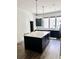 Sleek kitchen island with ample countertop space, dark cabinetry and modern pendant lighting at 1153 Reynolds Square Ln # 16, Atlanta, GA 30307