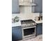 Modern kitchen with stainless steel appliances, white subway tile backsplash and dark blue cabinetry at 1153 Reynolds Square Ln # 16, Atlanta, GA 30307