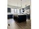 Modern kitchen with dark cabinetry, stainless steel appliances, and spacious island with bar seating at 1153 Reynolds Square Ln # 16, Atlanta, GA 30307