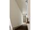 Bright and airy staircase with wooden stairs and white walls leading to the upper level at 1153 Reynolds Square Ln # 16, Atlanta, GA 30307