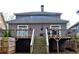 Rear of the house shows a wooden deck with stairs leading down to the backyard at 2132 Memorial Se Dr, Atlanta, GA 30317
