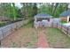 Aerial view of the backyard, which is enclosed by a wooden fence and features a detached garage at 2132 Memorial Se Dr, Atlanta, GA 30317