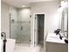 Modern bathroom with a glass-enclosed shower, soaking tub, double vanity, and contemporary fixtures at 2132 Memorial Se Dr, Atlanta, GA 30317