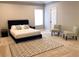 Spacious bedroom featuring a comfortable bed, neutral walls, and a decorative rug at 2132 Memorial Se Dr, Atlanta, GA 30317