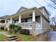 Inviting home featuring a covered front porch with ceiling fans and tasteful landscaping at 2132 Memorial Se Dr, Atlanta, GA 30317