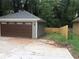 Detached two-car garage with a brown garage door and beige siding, offering ample parking space at 2132 Memorial Se Dr, Atlanta, GA 30317