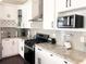 Well-equipped kitchen with stainless steel appliances, light countertops, and ample cabinet space at 2132 Memorial Se Dr, Atlanta, GA 30317