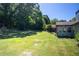 Expansive lawn in backyard of a house surrounded by lush greenery and trees under a clear sky at 3335 Ivy Lake Dr, Buford, GA 30519