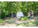Wooded backyard featuring a white storage shed, swing set, and trampoline, offering ample outdoor space at 3335 Ivy Lake Dr, Buford, GA 30519
